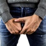 testicles, testicular cancer, cancer of the penis, pains, venereal diseases, man, pool, jeans, hands