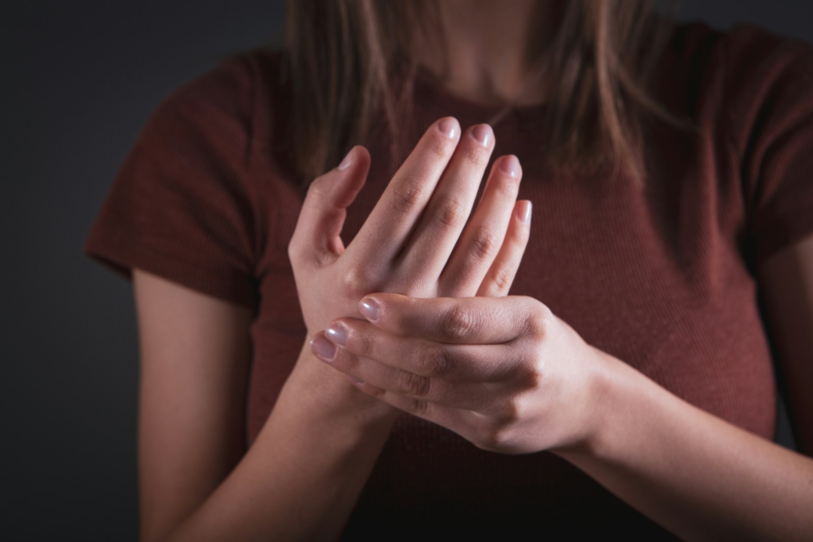 Woman holding her hand with pain